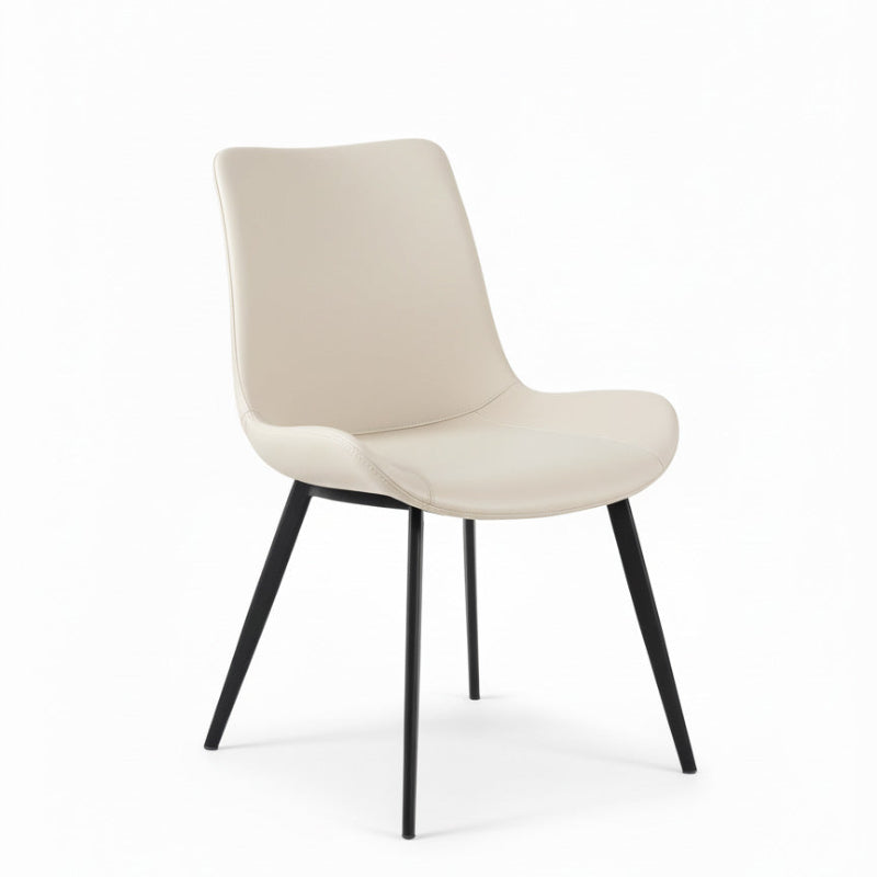 SADE contemporary dining chair 45-degree perspective, showcasing the ergonomic white faux leather seat and slender black metal tapered legs.