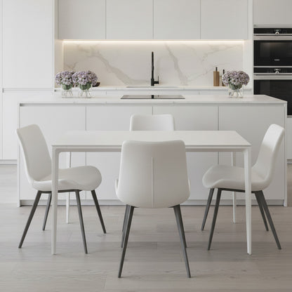 RAG Contemporary Dining Table with a white top and white aluminum base, set in a bright, all-white modern kitchen and dining area. The table is surrounded by four white dining chairs with dark legs.