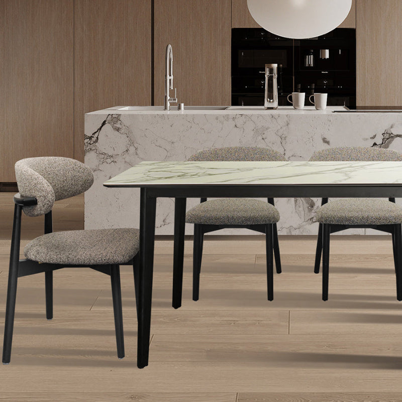 CROIST chair with grey fabric and black wood frame used as a minimalist accent seat in a bright, contemporary interior space.