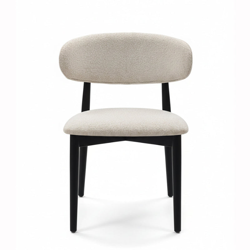 Front view of the CROIST chair, highlighting the unique curved black wood backrest and supportive off-white fabric cushion.