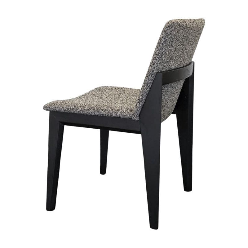 FOD modern dining chair back side view with solid black wood legs and grey fabric upholstery.