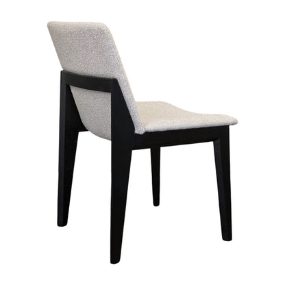 FOD modern dining chair back side view with solid black wood legs and soft off-white fabric upholstery.