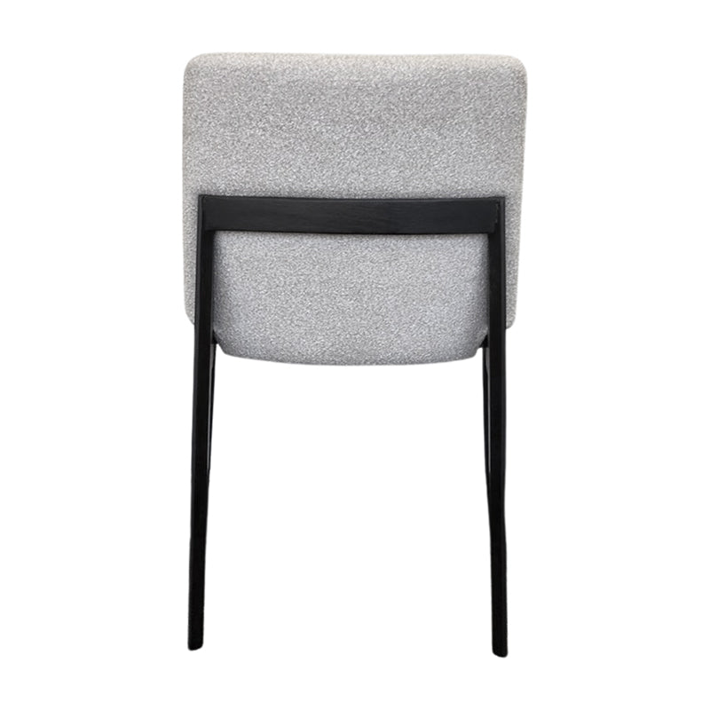 FOD modern dining chair back view with solid black wood legs and soft off-white fabric upholstery.