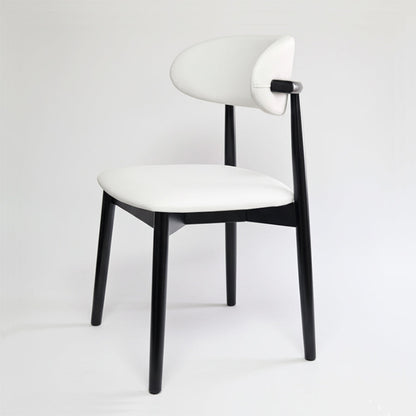 KROSNT modern minimalist dining chair with round black wood back and white faux leather seat on a clean white background.