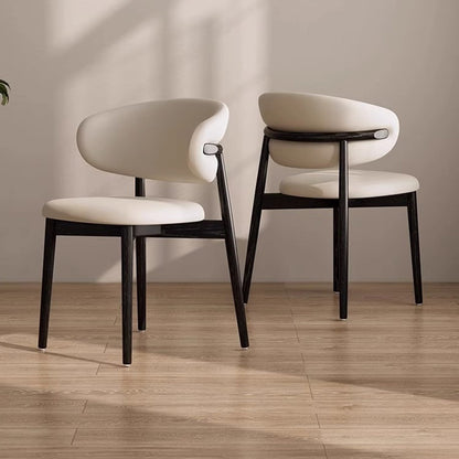 Two KROSNT chairs placed back-to-back in a sunlit, modern dining room setting with hardwood floors.