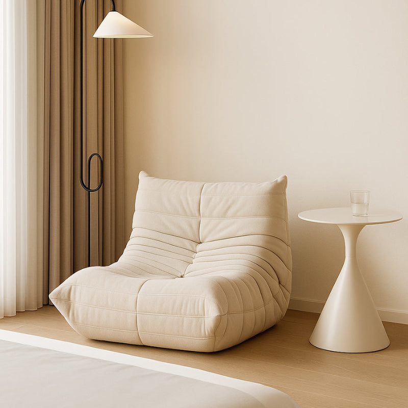 Ergonomic Togo-style single seater in off-white fabric, featuring a pleated frameless design for modern Toronto living rooms.