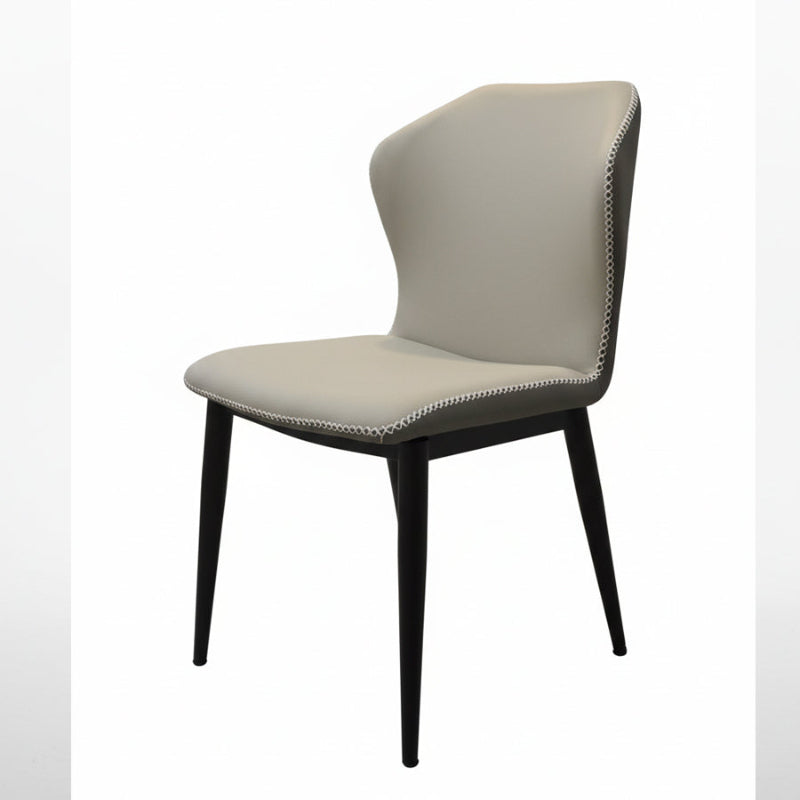 BF modern dining chair side view, beige faux leather seat with contrast stitching and black metal legs.