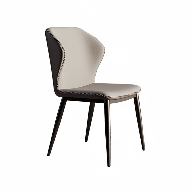 45-degree angle view of the BF dining chair, featuring beige faux leather on the front seat and backrest, dark grey sides with contrast stitching details, supported by tapered black metal legs.