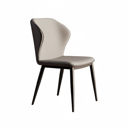 45-degree angle view of the BF dining chair, featuring beige faux leather on the front seat and backrest, dark grey sides with contrast stitching details, supported by tapered black metal legs.