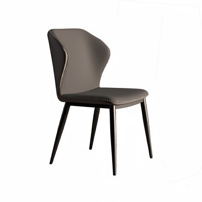 45-degree angle view of the modern BF dining chair, upholstered entirely in uniform dark grey faux leather with prominent contrast stitching details, supported by black tapered metal legs.