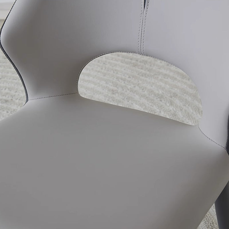 Detail shot of MYRIN upholstered chair padded faux leather seat