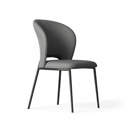 GIMOTI dining chair in deep charcoal grey faux leather, featuring the ergonomic curved silhouette and minimalist black metal legs.