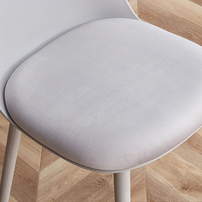 Close-up detail of the MACARON chair's removable light grey leathaire cushion, resting on the contoured PP plastic seat.