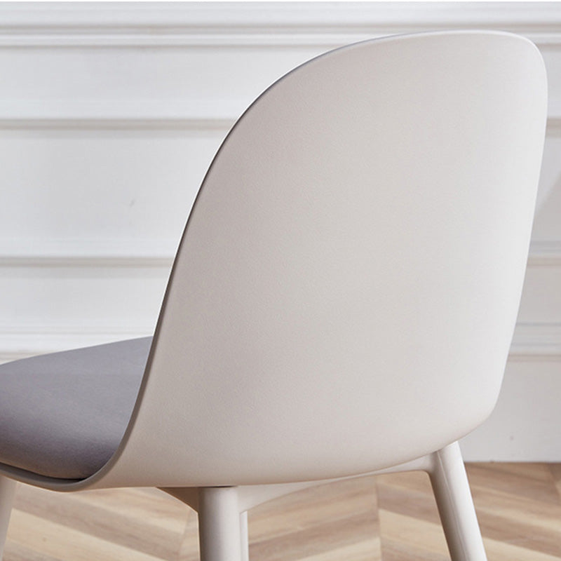 Back and side view of the MACARON chair's light grey contoured PP plastic shell, with a glimpse of the upholstered seat cushion.