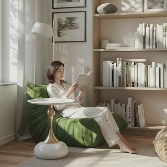 Video showcasing the white and gold Golp side table beside a green Togo sofa