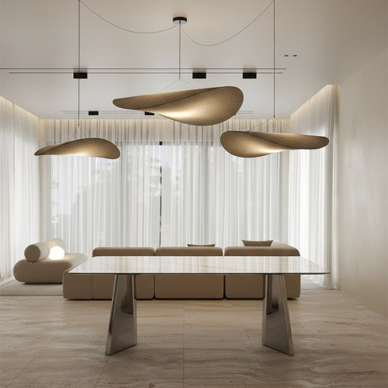 ARYLLIS marble-pattern sintered stone dining table styled in a modern interior setting with a reflective stainless steel base.