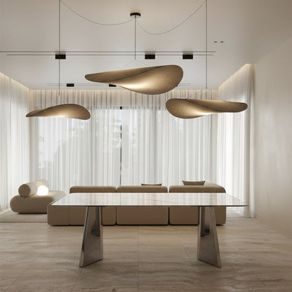 ARYLLIS marble-pattern sintered stone dining table styled in a modern interior setting with a reflective stainless steel base.