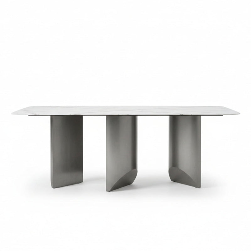 BVEL Sintered Stone dining table, front view perspective. Features a white marble-look top and sculptural gunmetal grey steel legs, ideal for a modern dining room.