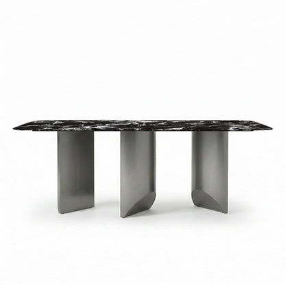 BVEL Sintered Stone dining table, front view perspective. Features a black marble-look top and sculptural gunmetal steel legs, ideal for a modern dining room.