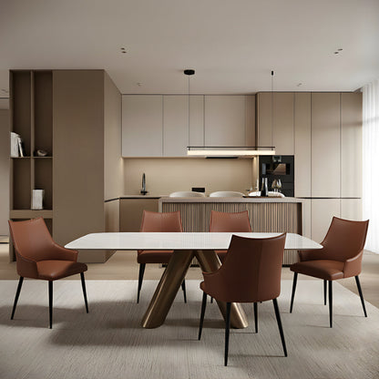 CYROLIN sintered stone dining table placed in front of a kitchen bar area, highlighting its modern stone surface and bronze-look steel base.