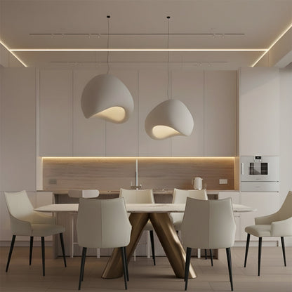 CYROLIN dining table styled in a contemporary kitchen setting, showcasing its sintered stone tabletop and bronze-finished steel frame.