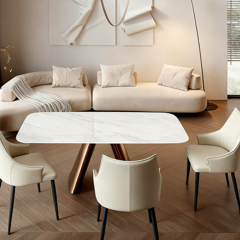 CYROLIN sintered stone dining table featured in a modern living–dining room space, emphasizing its minimalist stone top and bronze-look steel structure.