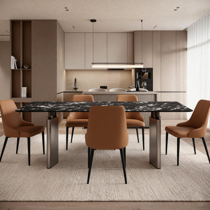 Lifestyle scene: The DIMON Black Sintered Stone table (180cm) paired with modern chairs, positioned in front of a clean kitchen island, creating a sophisticated open-concept dining area.