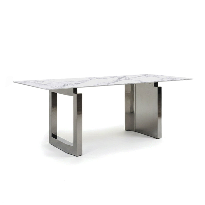 45-degree angle view of the HUXI dining table with a sintered stone top and mirror-finish steel base.