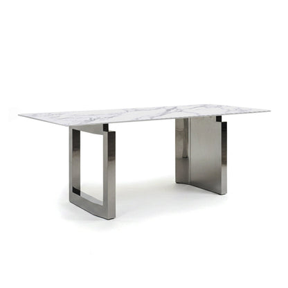 45-degree angle view of the HUXI dining table with a sintered stone top and mirror-finish steel base.