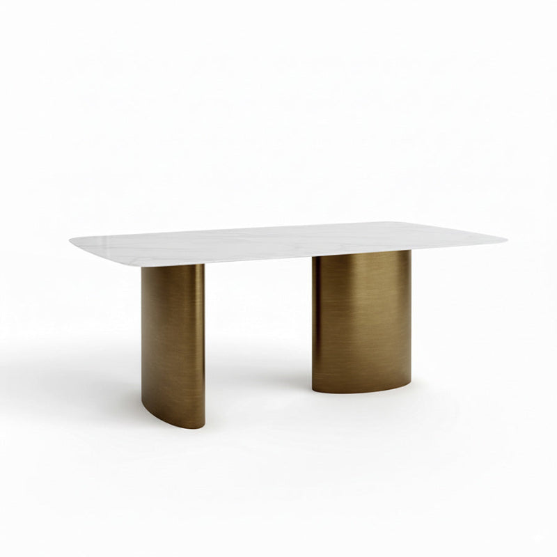 Oblique angled view from above of the MIVANO dining table, showcasing the spacious 180cm/71in Sintered Stone surface resting on the reflective Antique Bronze pedestal supports.