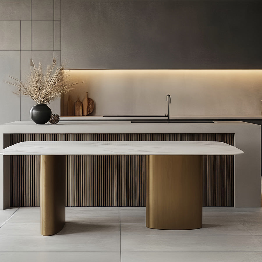 Modern open-concept kitchen scene featuring the standalone MIVANO Sintered Stone dining table positioned centrally in front of a large kitchen island and bar counter.