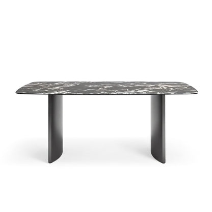 Front perspective view of the OLIV dining table featuring a Bvlgari Black glossy sintered stone top with stainless steel legs.