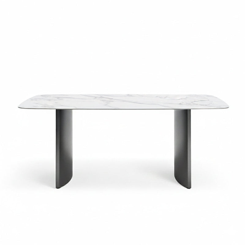 Front perspective view of the OLIV dining table with Snowy Mountain White glossy sintered stone top and stainless steel legs on a white background.
