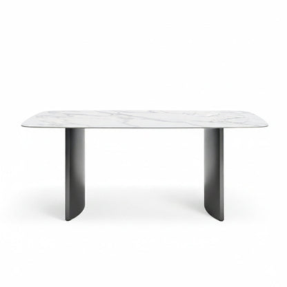 Front perspective view of the OLIV dining table with Snowy Mountain White glossy sintered stone top and stainless steel legs on a white background.