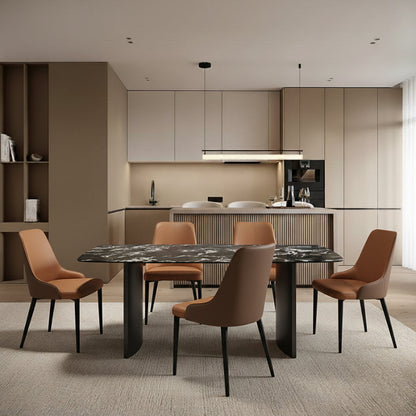 OLIV dining table styled in a modern kitchen bar area, showcasing the sintered stone top and stainless steel legs in a bright interior setting.