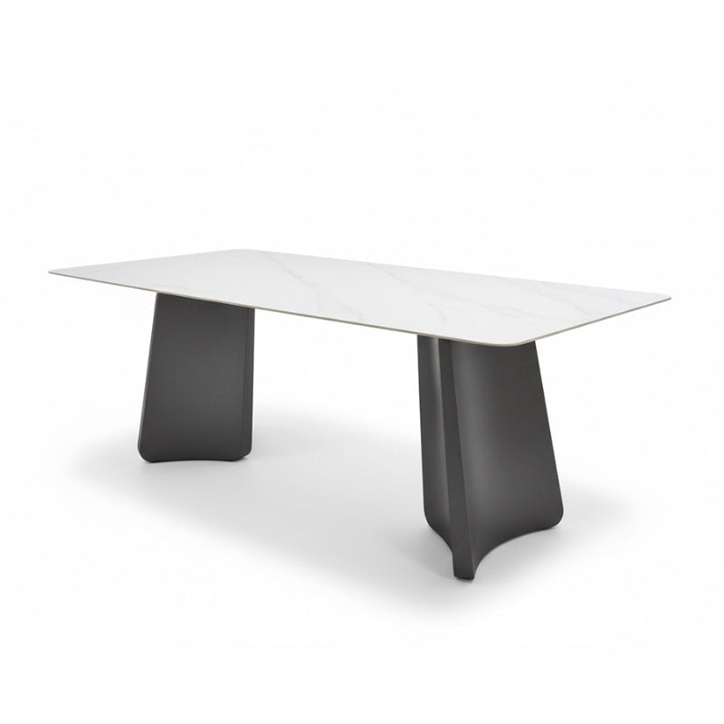 Right-angled oblique view of the PETLS dining table on a white background, emphasizing the architectural design of its wide, angled gunmetal grey steel bases and the spacious 79in Sintered Stone top.