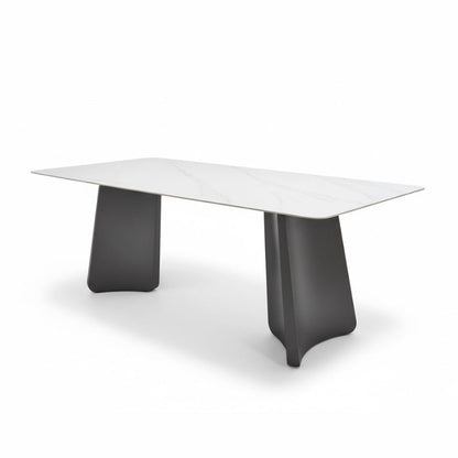 Right-angled oblique view of the PETLS dining table on a white background, emphasizing the architectural design of its wide, angled gunmetal grey steel bases and the spacious 79in Sintered Stone top.