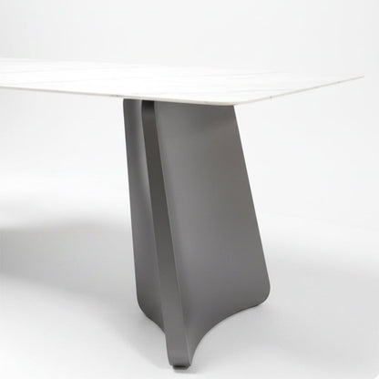 Close-up detail shot of the PETLS dining table's wide, angled gunmetal grey steel pedestal leg, highlighting its smooth finish and sturdy construction.