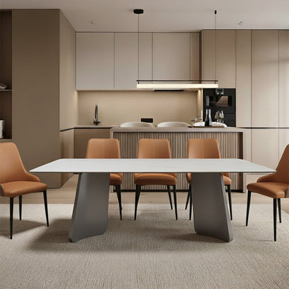Vibrant lifestyle scene: The PETLS Sintered Stone dining table with a white top, accented by the bold orange faux leather dining chairs, placed in front of a sleek kitchen island.