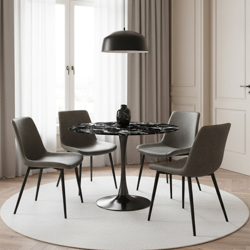 Elegant dining room scene featuring the TULIP 90CM Round Table with a Black Bulgari ceramic top and a matte grey base, paired with modern grey faux leather dining chairs.