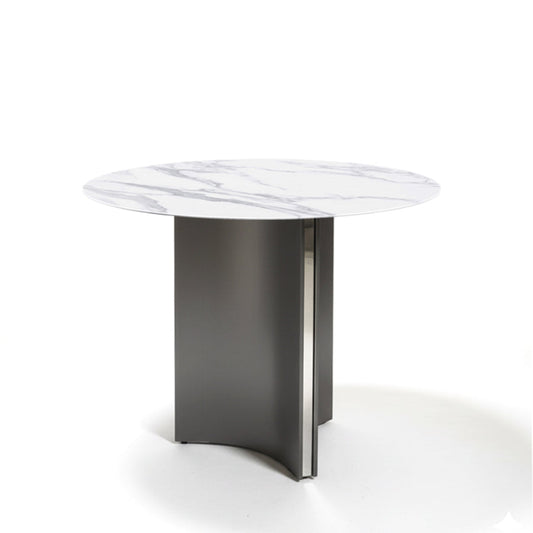 Angled view of the LUMARA 90cm (35.5in) round dining table with a snow mountain white marble-pattern sintered stone top on a white background.