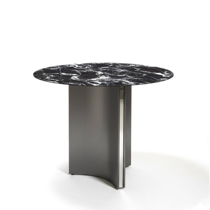 Angled view of the LUMARA 90cm (35.5in) round dining table featuring a bulgary black marble-pattern sintered stone top on a white background.
