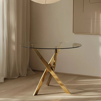 TRINITY round glass dining table styled in a modern room, showcasing its clear 39-inch glass top and contemporary gold mirror-finish stainless steel base.