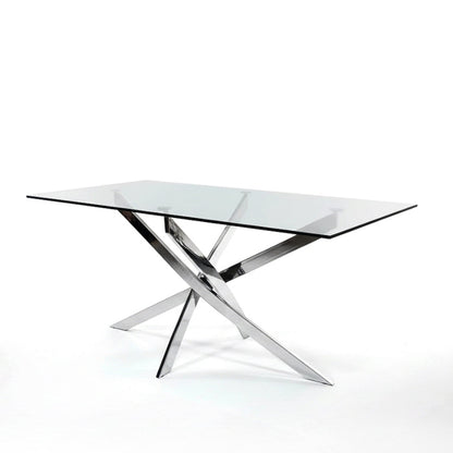 45-degree angled view of the VERDIS glass dining table featuring a clear tempered glass top and mirror-finish stainless-steel legs