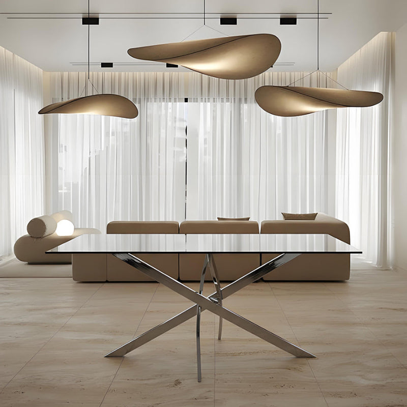 VERDIS glass dining table with mirror stainless-steel base displayed in a modern home interior setting