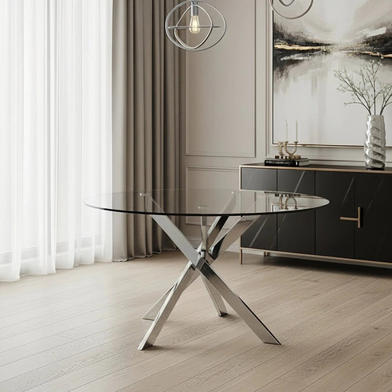 VERDIS round glass dining table with mirror stainless-steel base displayed in a modern home interior setting