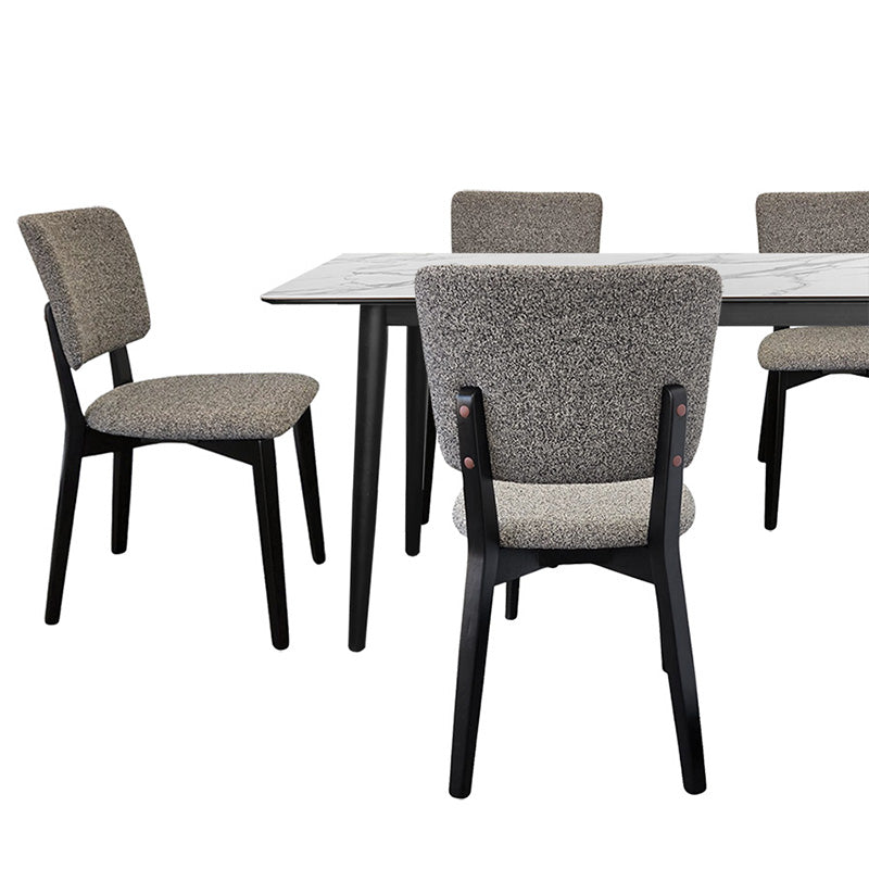 BASK grey fabric dining chair paired with a modern wood dining table featuring a white marble-patterned top.
