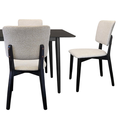 BASK off-white fabric dining chair paired with a modern wood dining table featuring a black top.