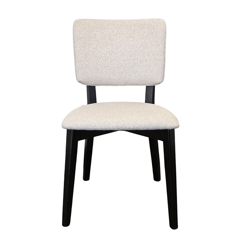 BASK modern dining chair front view with solid black wood legs and soft off-white fabric upholstery.