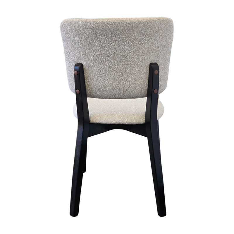 BASK modern dining chair back view with solid black wood legs and soft off-white fabric upholstery.
